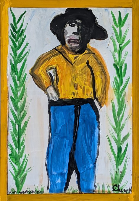 Standing figure wearing a yellow shirt, blue trousers, and black hat between green branches.
